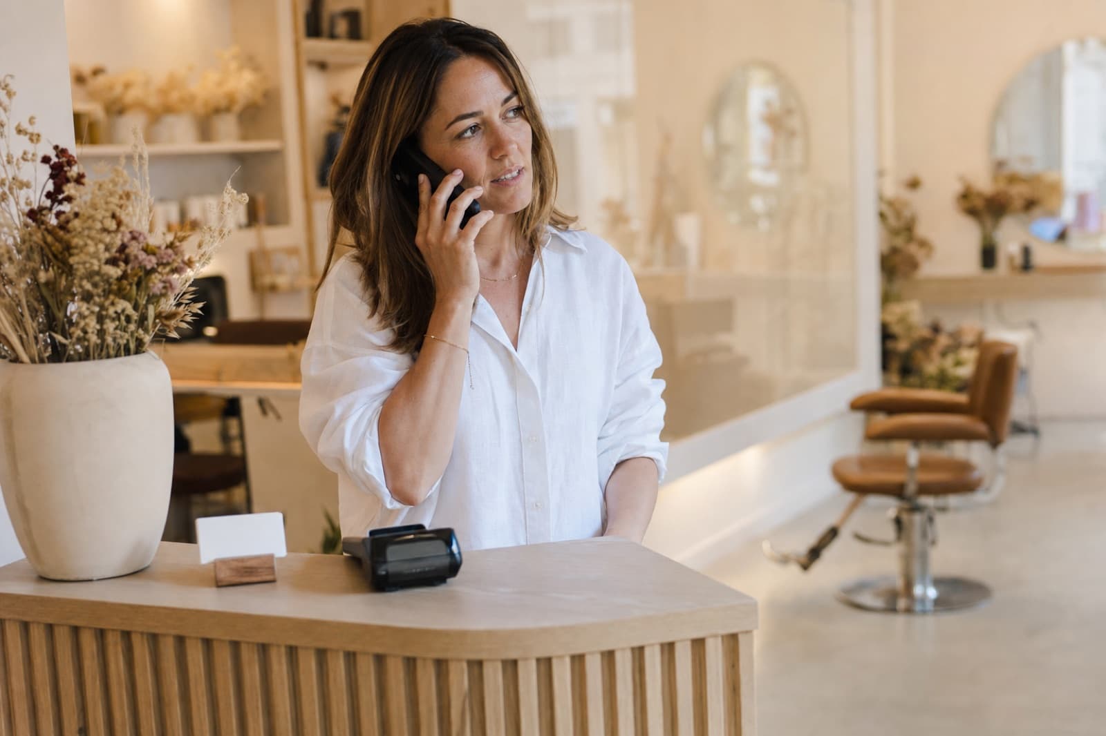 Beauty business owner interrupted by a phone call during the working day